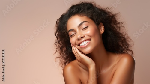 Beautiful smiling young woman with soft glow skin and bare shoulders. photo