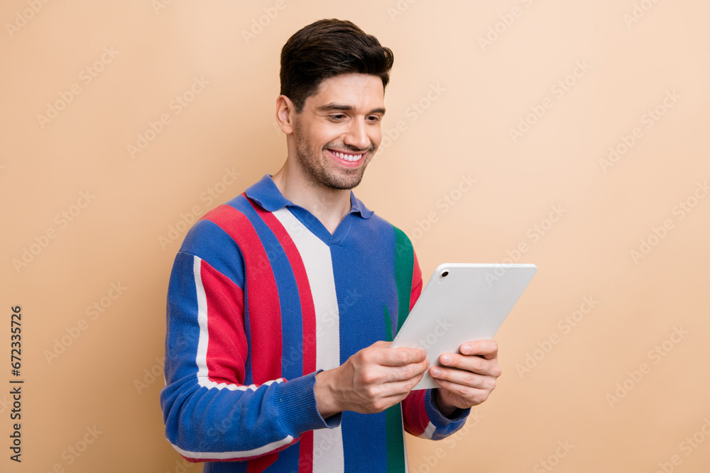 Photo of business data analytic browsing tablet answering his boss chat message about agreement details isolated on beige color background Photo of business data analytic browsing tablet answering his boss chat message about agreement details isolated on beige color background