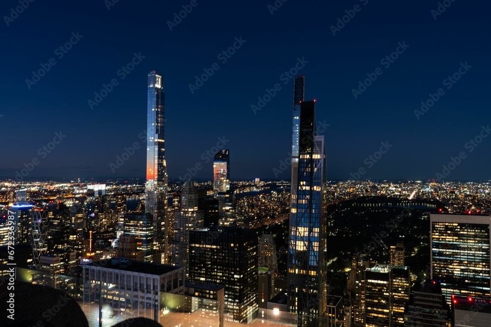 Aerial view of a Rockefeller Center in New York lit up at nightw with illuminated skyscrapers