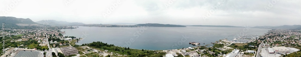 Aerial panoramic view of houses against the sea on a cloudy day