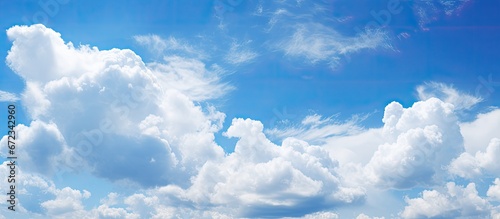 A background of white clouds against a blue sky photo