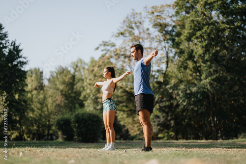 Caucasian couple engages in outdoor workout, stretching, and practicing with ropes. They value fitness, persistence, and a healthy lifestyle in the natural environment of a park. © qunica.com