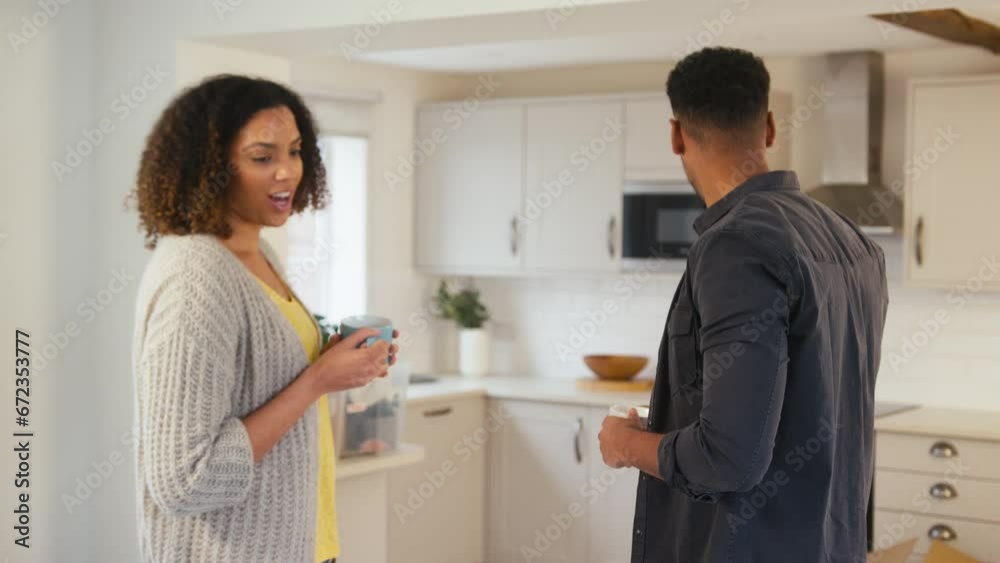 Couple taking coffee break from unpacking boxes in new home on moving day - shot in slow motion Couple taking coffee break from unpacking boxes in new home on moving day - shot in slow motion