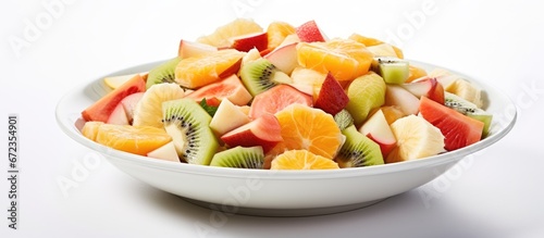 A plate of fresh fruit including banana kiwi orange grapefruit and pineapple makes for a nutritious morning meal