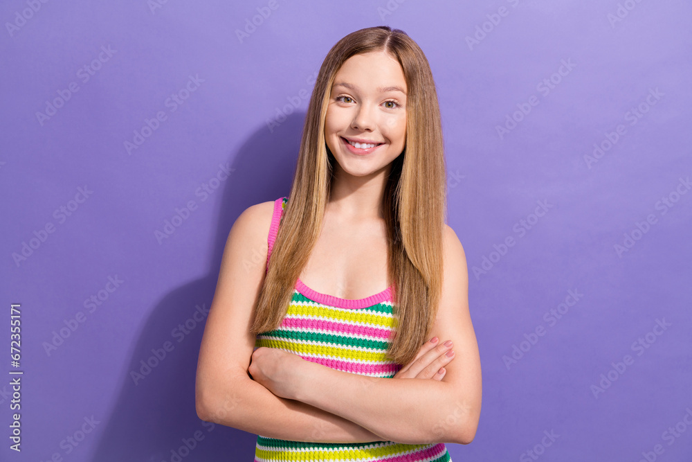 Portrait of toothy beaming teen girl with long hairstyle wear colorful singlet standing hold arms crossed isolated on purple background Portrait of toothy beaming teen girl with long hairstyle wear colorful singlet standing hold arms crossed isolated on purple background
