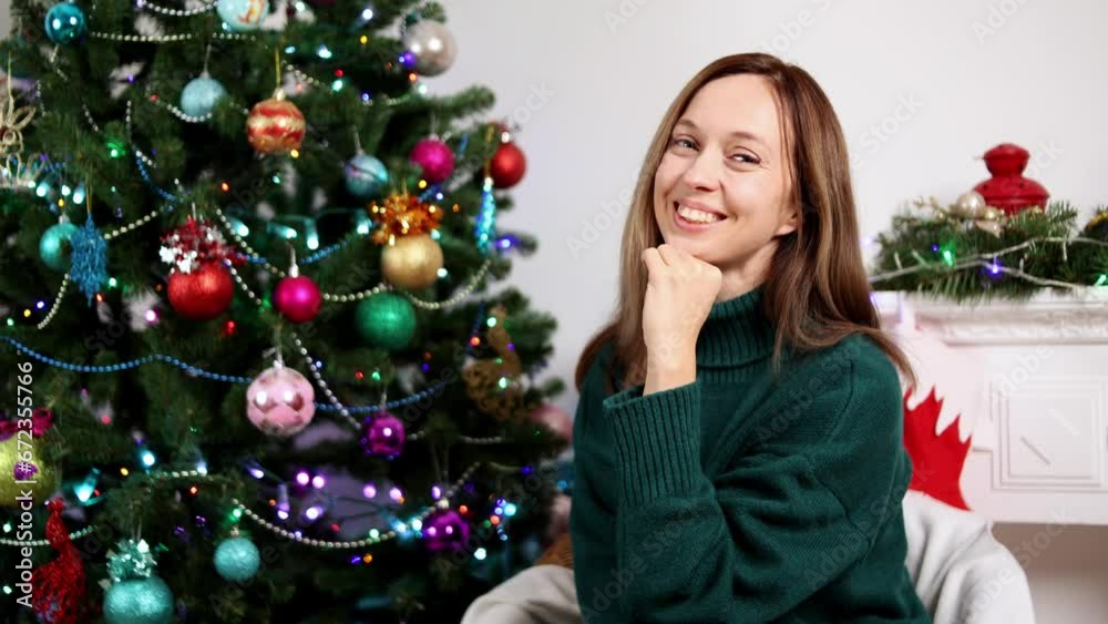 Close-up portrait of a smiling girl on the background of a Christmas tree, New Year Close-up portrait of a smiling girl on the background of a Christmas tree, New Year
