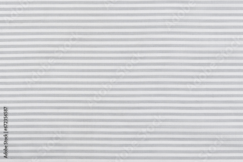 close-up texture of natural cotton calico fabric in gray and white stripes. background for your mockup