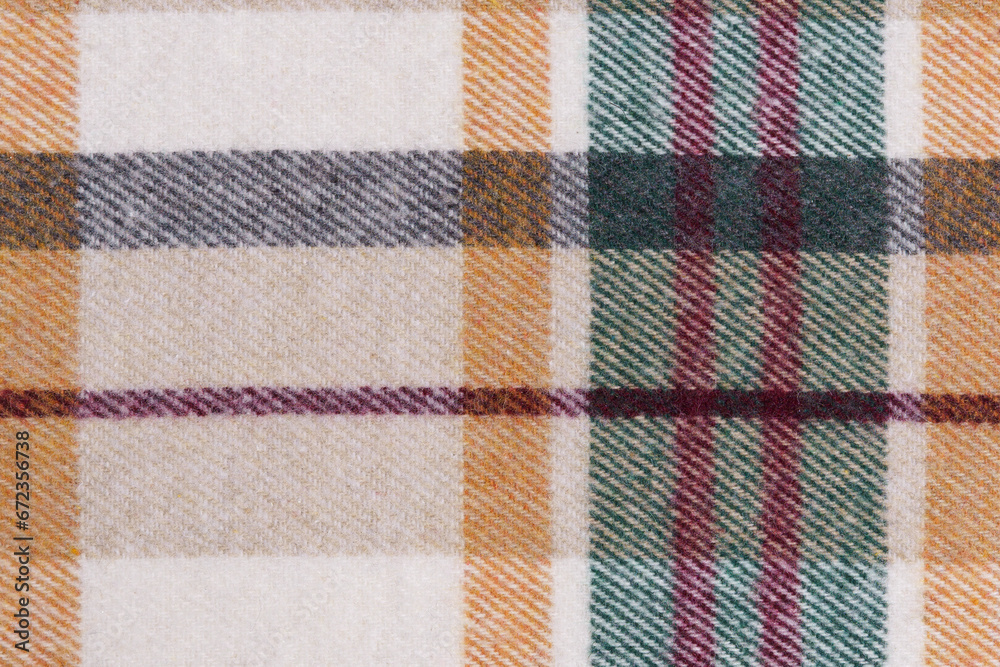 close-up texture of warm checkered tartan fabric in beige, green and red colors. Image for your design. material for making warm clothes and shirts