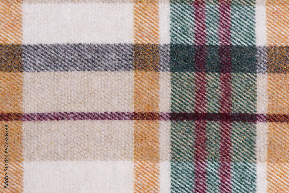 close-up texture of warm checkered tartan fabric in beige, green and red colors. Image for your design. material for making warm clothes and shirts close-up texture of warm checkered tartan fabric in beige, green and red colors. Image for your design. material for making warm clothes and shirts