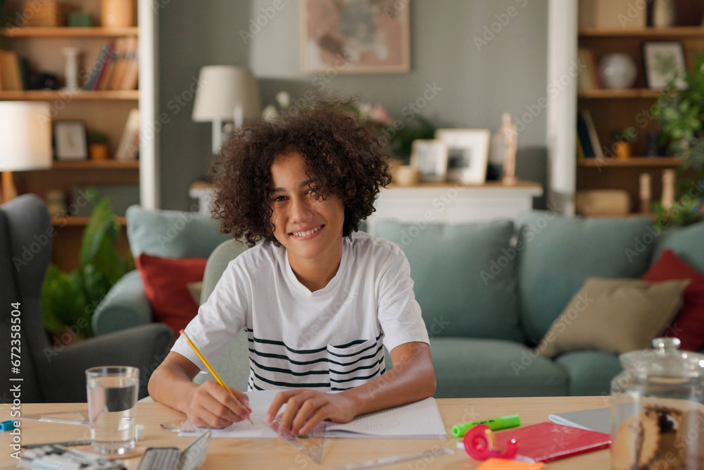 Teenage African-American boy studying at home Teenage African-American boy studying at home
