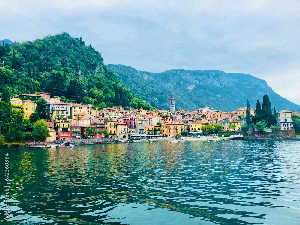 Picturesque village of Como, Italy overlooking a tranquil lake surrounded by majestic mountain peaks