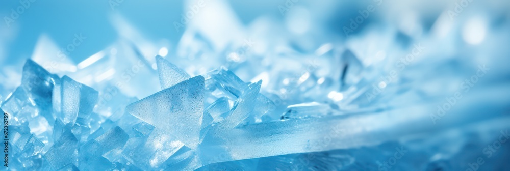 Close-up of radiant ice crystals forming a blue textured background with light reflections