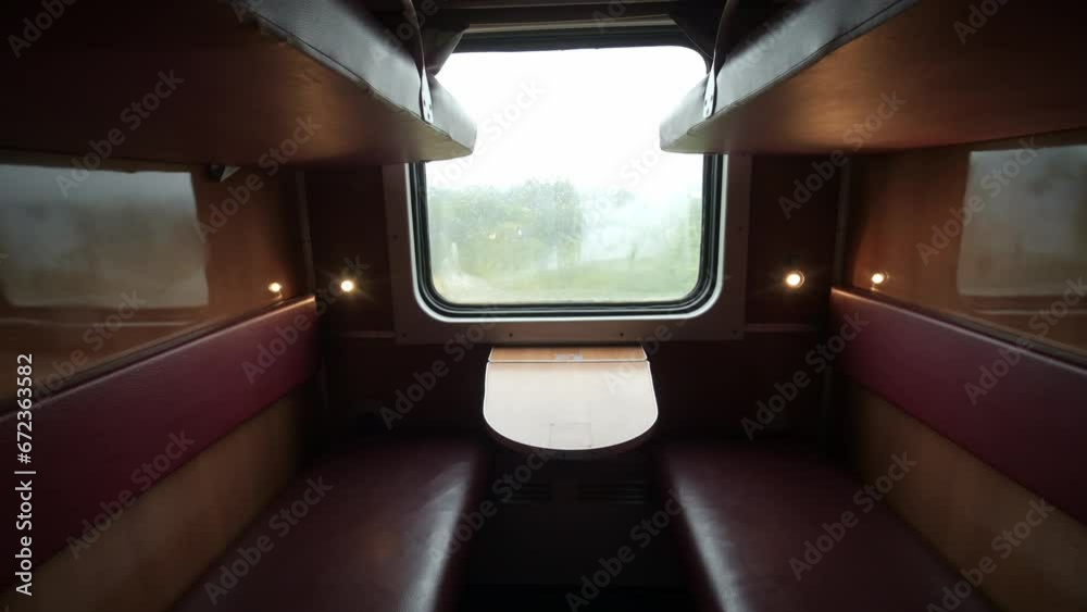 Empty train wagon. Empty passenger compartment in a moving train. Train compartment window. Empty railroad carriage . Travel and tourism. Locomotive.