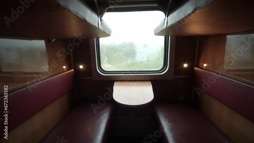 Empty train wagon. Empty passenger compartment in a moving train. Train compartment window. Empty railroad carriage . Travel and tourism. Locomotive.
