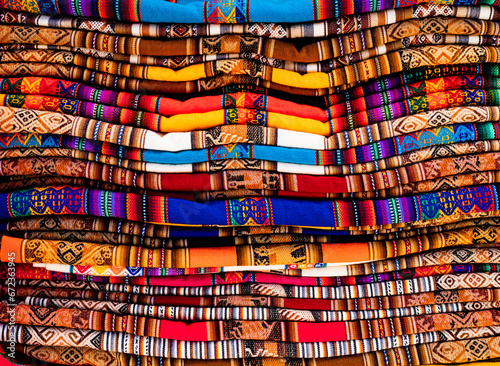Stack of multicolored andean textile and fabrics in Pisac traditional market, Peru
 photo
