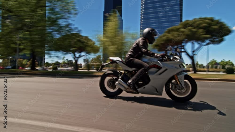 Man riding supersport motorcycle on the street of Madrid on a beautiful sunny day Man riding supersport motorcycle on the street of Madrid on a beautiful sunny day