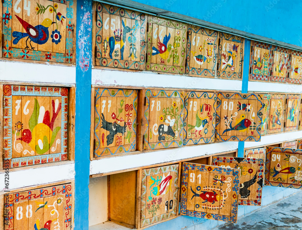 Colorful lockers at La Calera thermal waters, painted with traditional motifs and indigenous animals that populate the valley, Chivay, Peru
