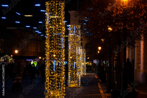 Colorful christmas lights with blurred street lights in the background at night