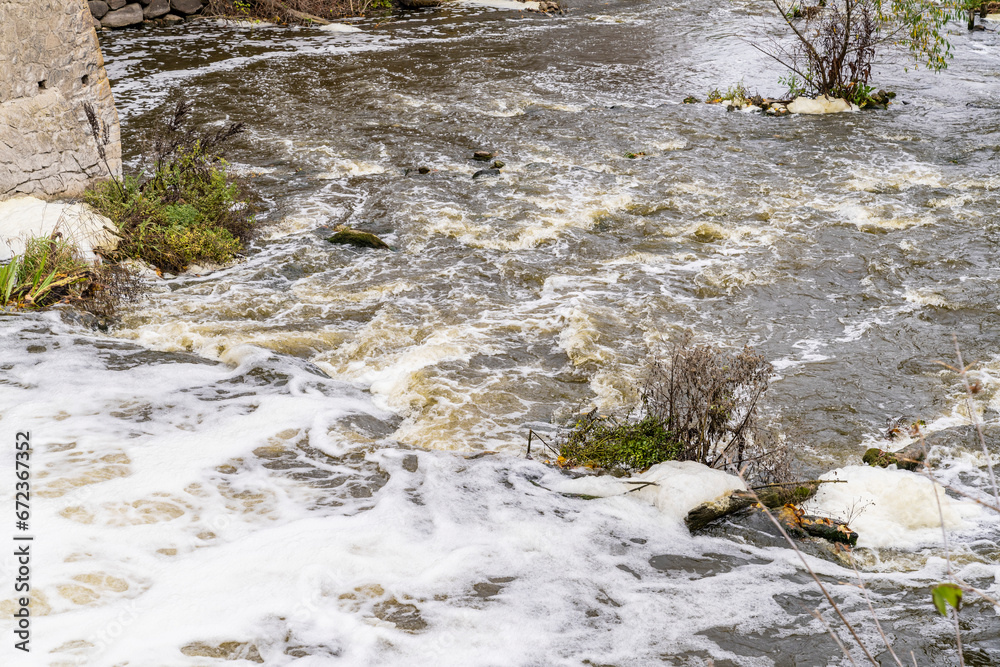 Nature, waterfall rapids. Fast current, splashes, water boils. Foam.