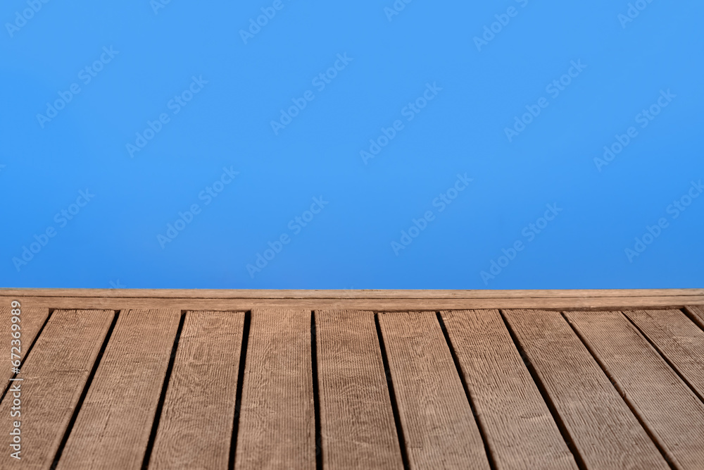 Wooden pier with blue surface of lake water, copy space for text