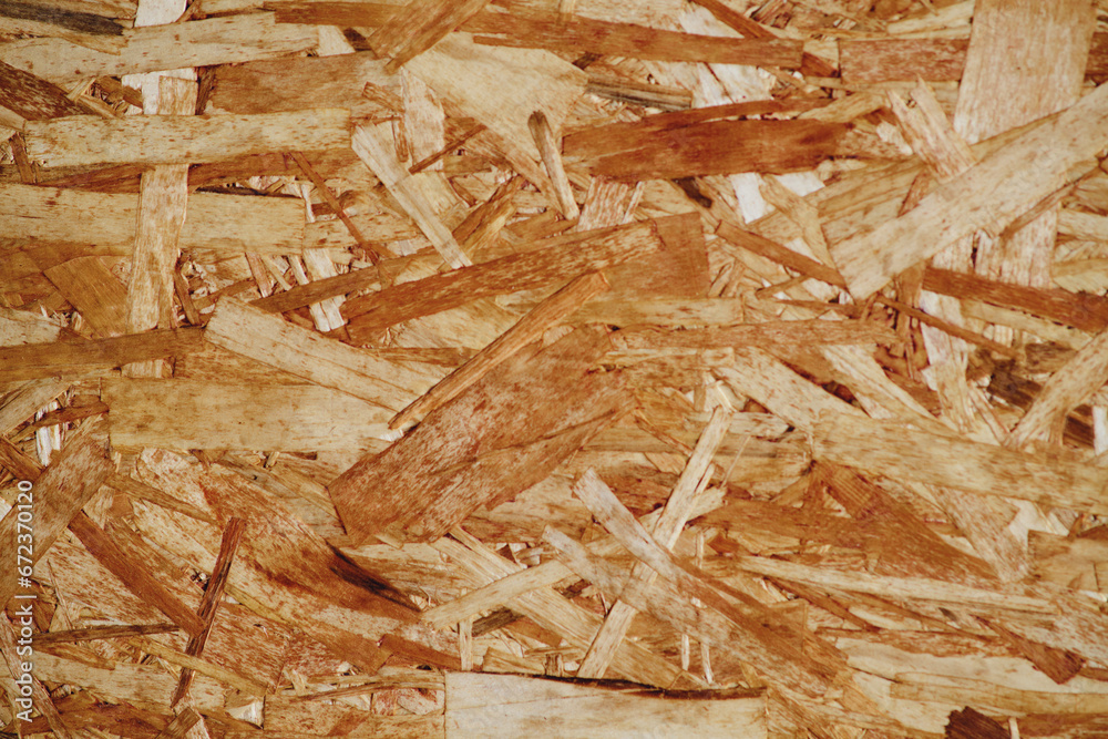 Chipboard background, wooden texture of chipboard material closeup Chipboard background, wooden texture of chipboard material closeup