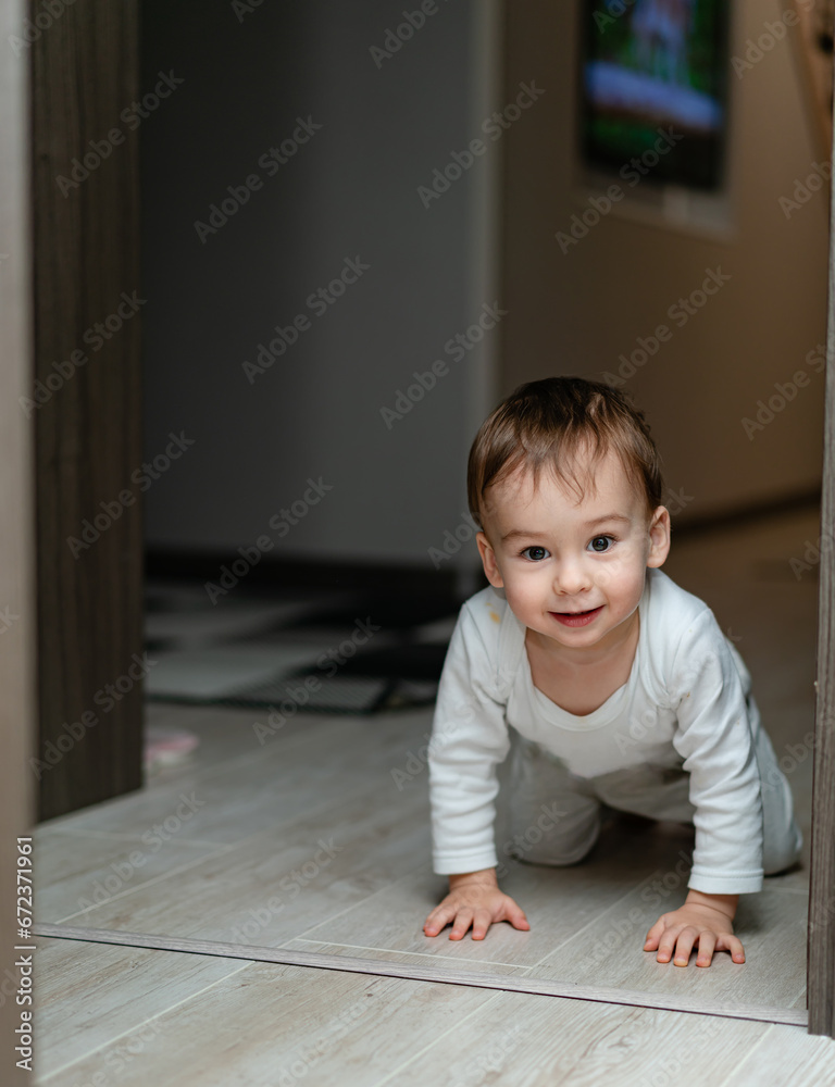 A Curious Baby Adventuring in Front of a Door A Curious Baby Adventuring in Front of a Door