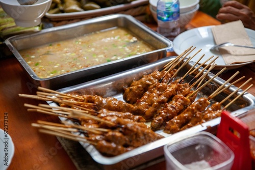 Table with a variety of Indonesian dishes like Satay and Soto Soup