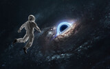 3D illustration of black hole and astronaut. 5K realistic science fiction art. Elements of image provided by Nasa