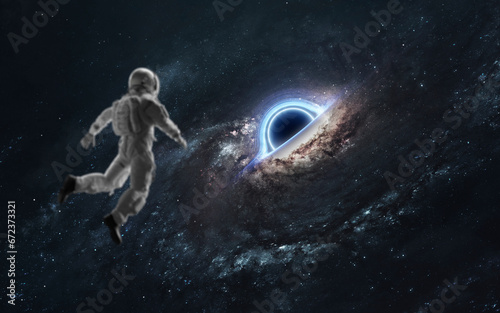 Fototapeta Naklejka Na Ścianę i Meble -  3D illustration of black hole and astronaut. 5K realistic science fiction art. Elements of image provided by Nasa