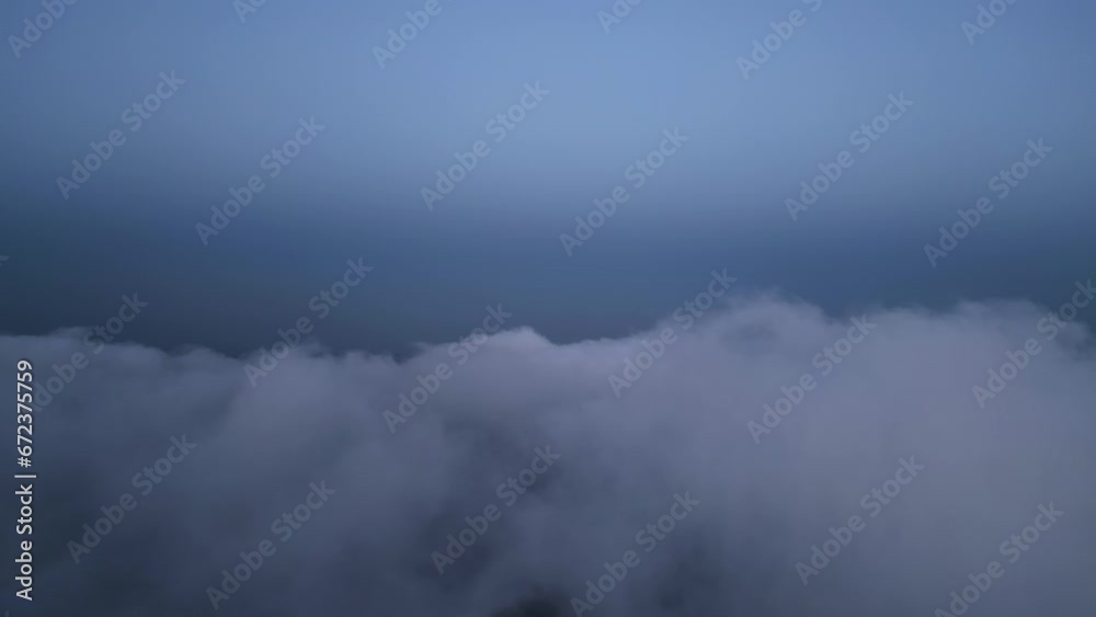 A drone flies over fluffy clouds at sunset. The drone flies through the clouds, creating a sense of wonder and awe A drone flies over fluffy clouds at sunset. The drone flies through the clouds, creating a sense of wonder and awe