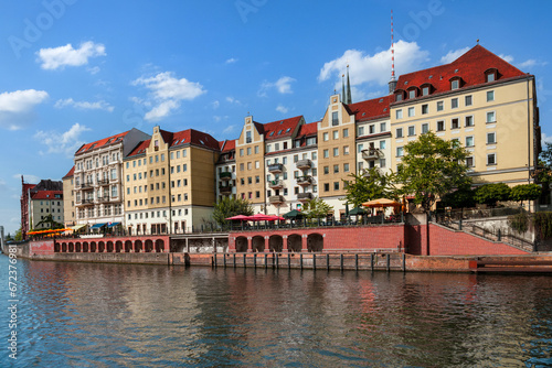 A row of buildings next to a body of water. River Spree in Berlin and old architecture.