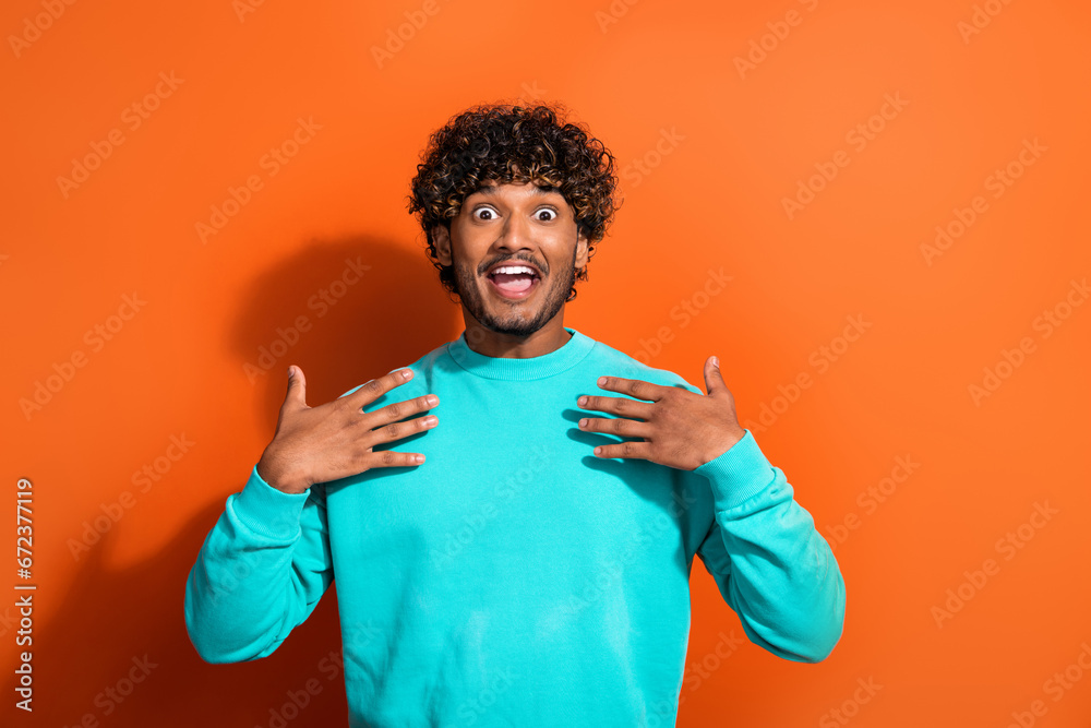 Portrait of impressed positive person hands touch chest open mouth unexpected news isolated on orange color background Portrait of impressed positive person hands touch chest open mouth unexpected news isolated on orange color background