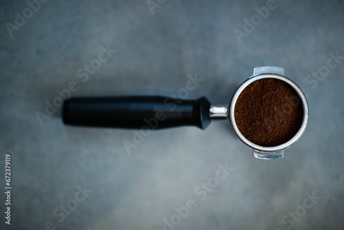 Close-up view of a portafilter with ground coffee for the coffee machine photo