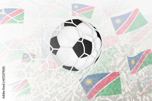 National Football team of Namibia scored goal. Ball in goal net, while football supporters are waving the Namibia flag in the background.