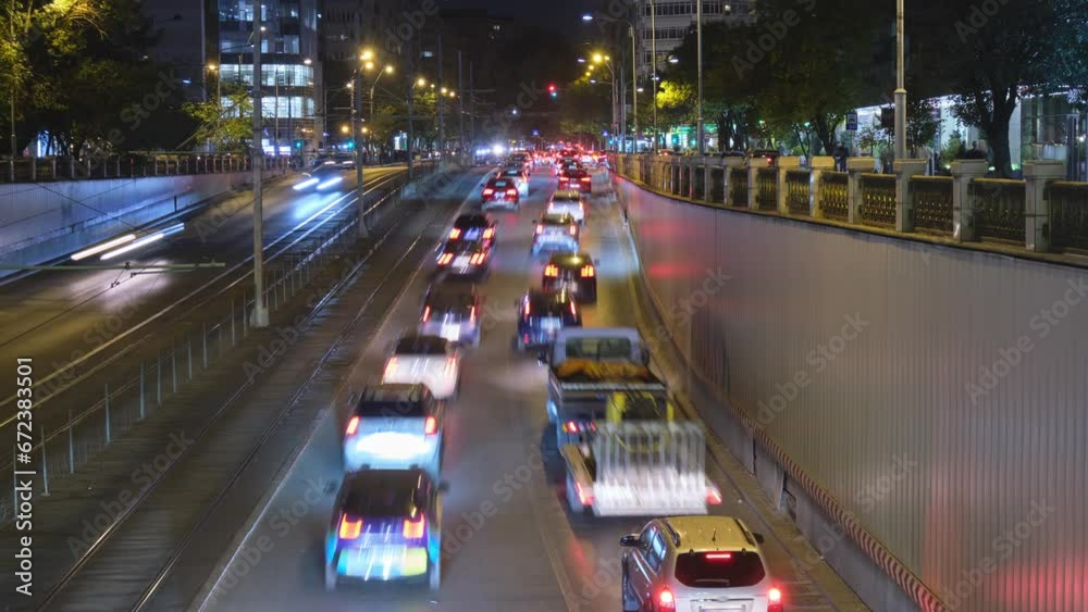 Late evening rush hour traffic in Bucharest, Romania, at an underpass called Pasajul Victoriei. Timelapse of car lights, night, inner city. Late evening rush hour traffic in Bucharest, Romania, at an underpass called Pasajul Victoriei. Timelapse of car lights, night, inner city.