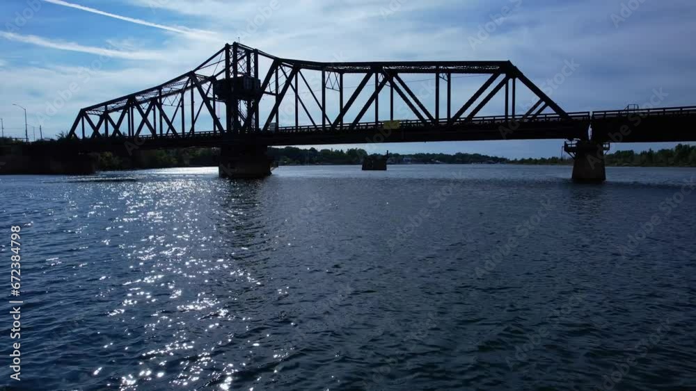 Little current swing bridge at sunny summer with blue sky. The bridge connects Manitoulin island and Goat island to the mainland and use for boats pass. Little current swing bridge at sunny summer with blue sky. The bridge connects Manitoulin island and Goat island to the mainland and use for boats pass.