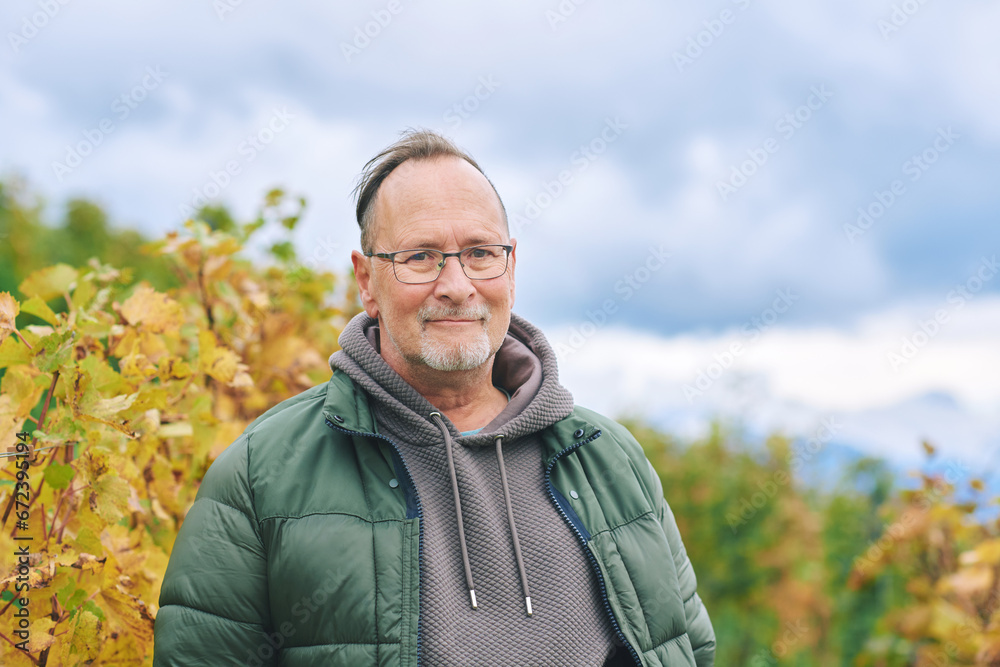 Outdoor portrait of middle age 55 - 60 year old man enjoing nice autumn day in vineyards, healthy and active lifestyle Outdoor portrait of middle age 55 - 60 year old man enjoing nice autumn day in vineyards, healthy and active lifestyle