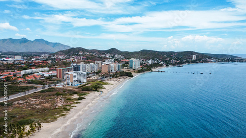 Photos from a drone of the Moreno Beach Margarita island and the angel rock momument.  Beach Landscape scenery and construction of houses in process photo
