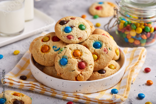 American cookies with colorful chocolate candy drops served with glass of milk. Delicious homemade dessert for children.
