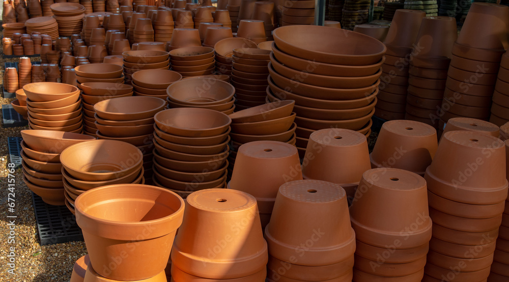 Clay pots of different sizes and trays for them. Different sizes for plants. Clay pots of different sizes and trays for them. Different sizes for plants.