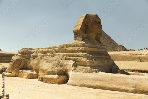 Iconic Sphinx stands guard at the Pyramids of Giza in Egypt on a sunny day