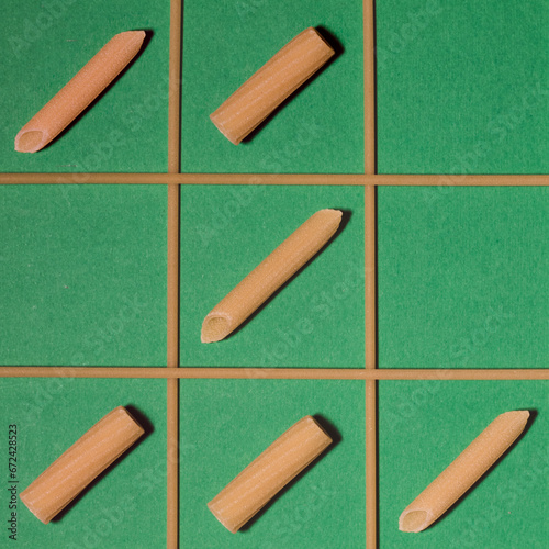 Famous game of tic-tac-toe played with penne and rigatoni.