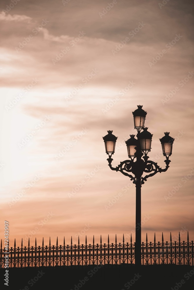 Vertical of a street lamp against the sky at sunset