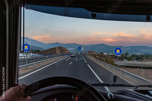 View from inside a truck of some traffic signs indicating that the highway on which it circulates is authorized for the transport of dangerous goods.