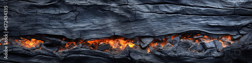 Fiery crack in dark textured wood photo