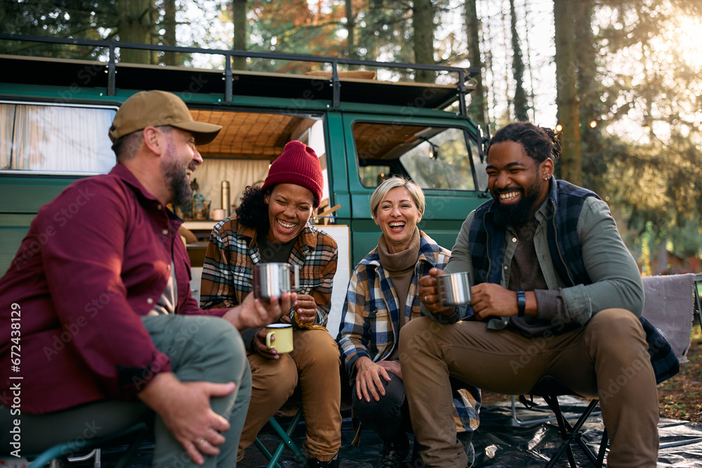 Multiracial cheerful friends have fun by camper trailer in woods. - obrazy, fototapety, plakaty 