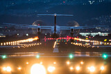 Large commercial airplane landing or take off on runway at night. Journey abroad tourism, oversea travel, flight transit, air travel transport, airline business, or transportation industry concept