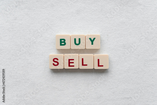 "Buy" and "sell" with green and red letters. Concept of buying and selling assets.