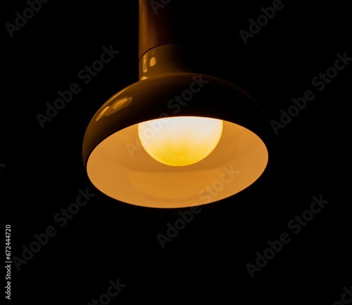 Bright lamp light illuminates a dark room, creating a warm, inviting atmosphere
