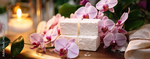 beautiful setup or orchid flowers and soap bars with candle for cosmetics and face wash natural spa products commercial as wide banner mockup display